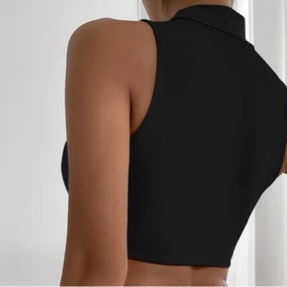 A cute black top shows, belly tank top and chest Just too small for me